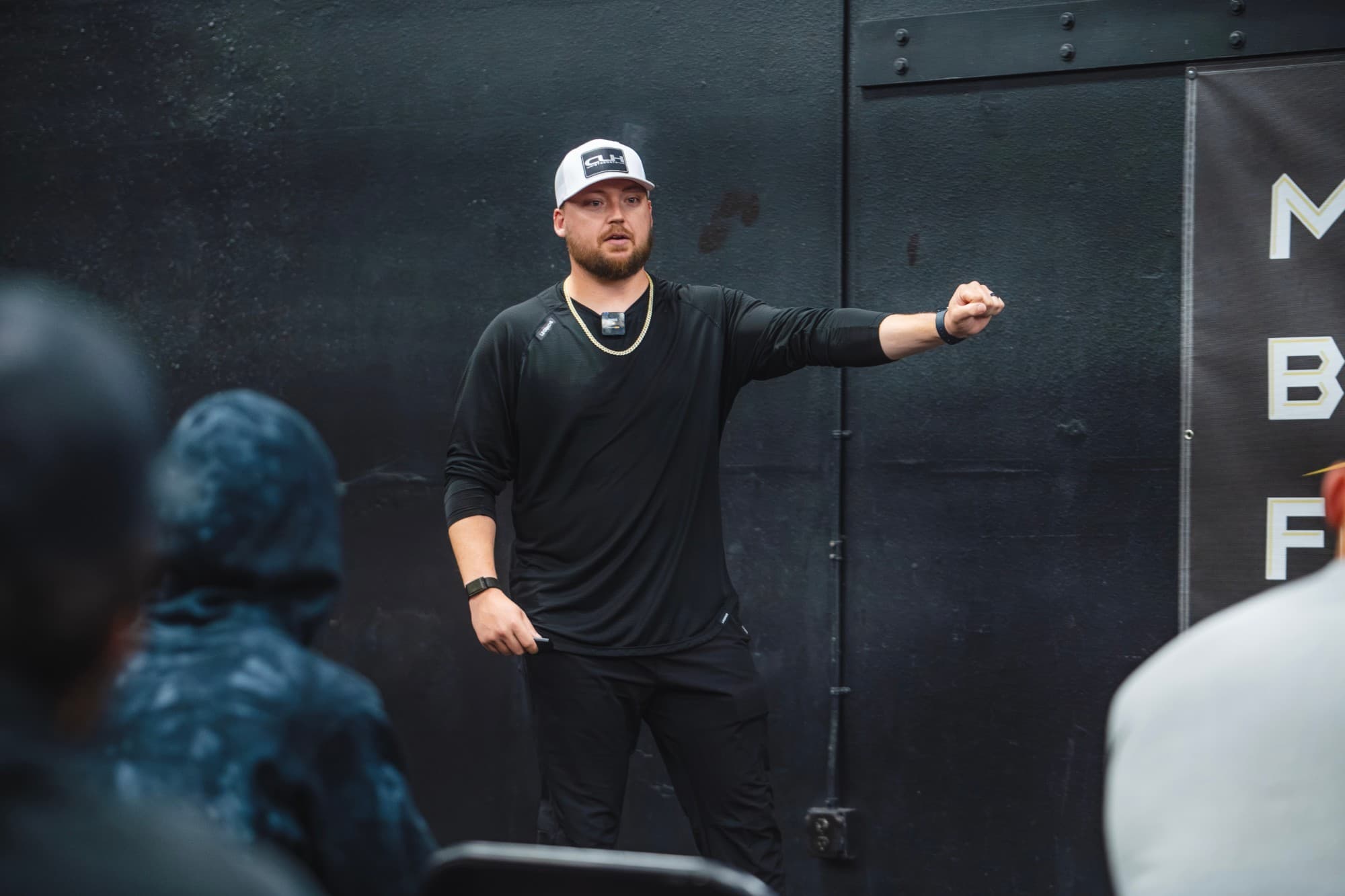 Cody Hughes speaking to a room of coaches